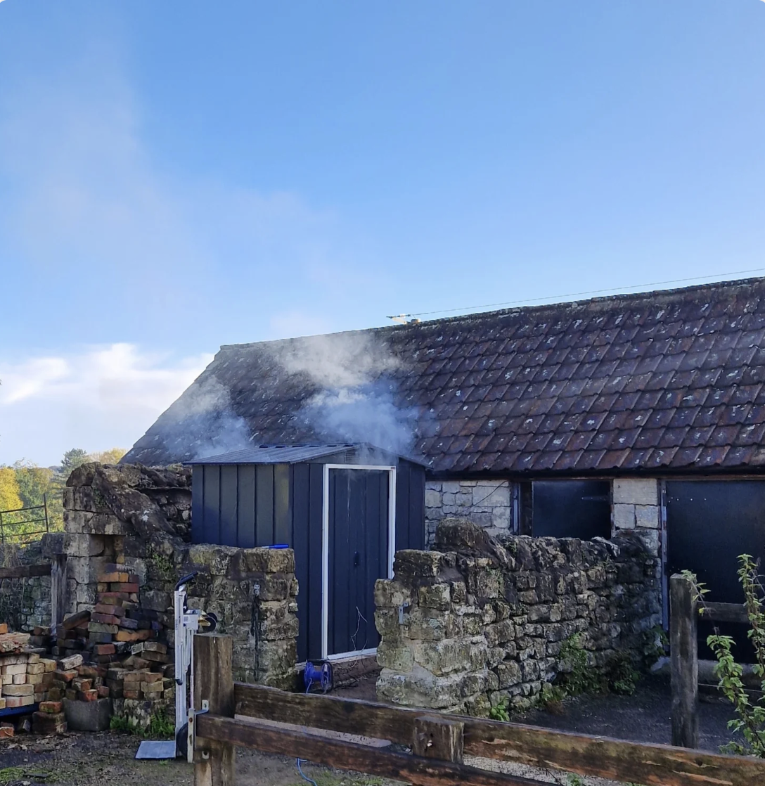 an image of the exterior of one of the smoking sheds at Retribution Distillery