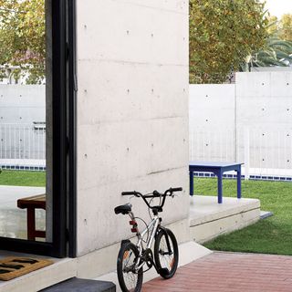 garden area with bicycle and concrete wall