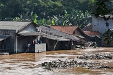 Residents in Jakarta stay on the second floor of their house amid floodwaters due to heavy rainfall in on April 26, 2019.