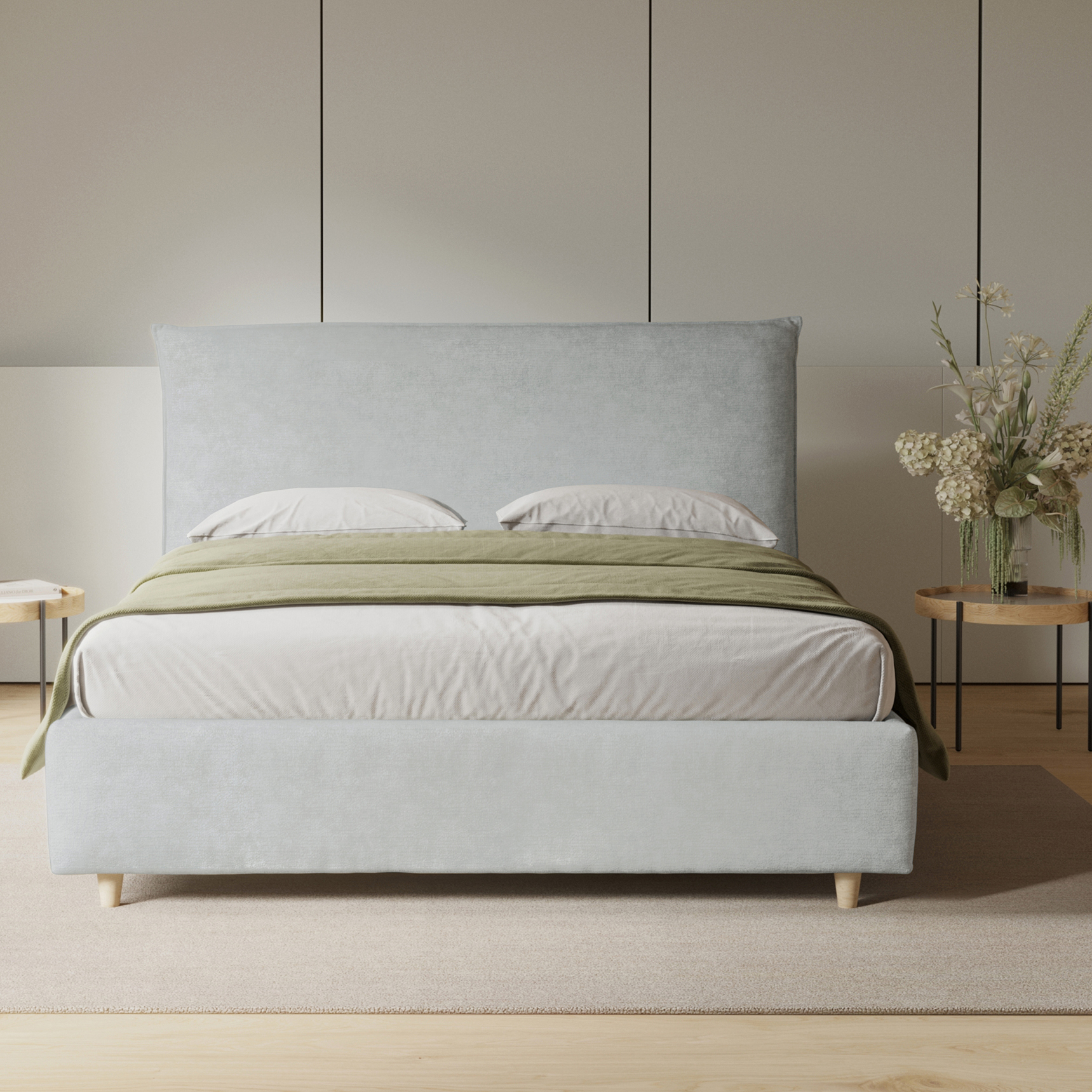 Beige upholstered bed in an off-white bedroom with panelled walls and light wood floors