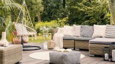 outdoor living scene with hanging chair and corner sofa