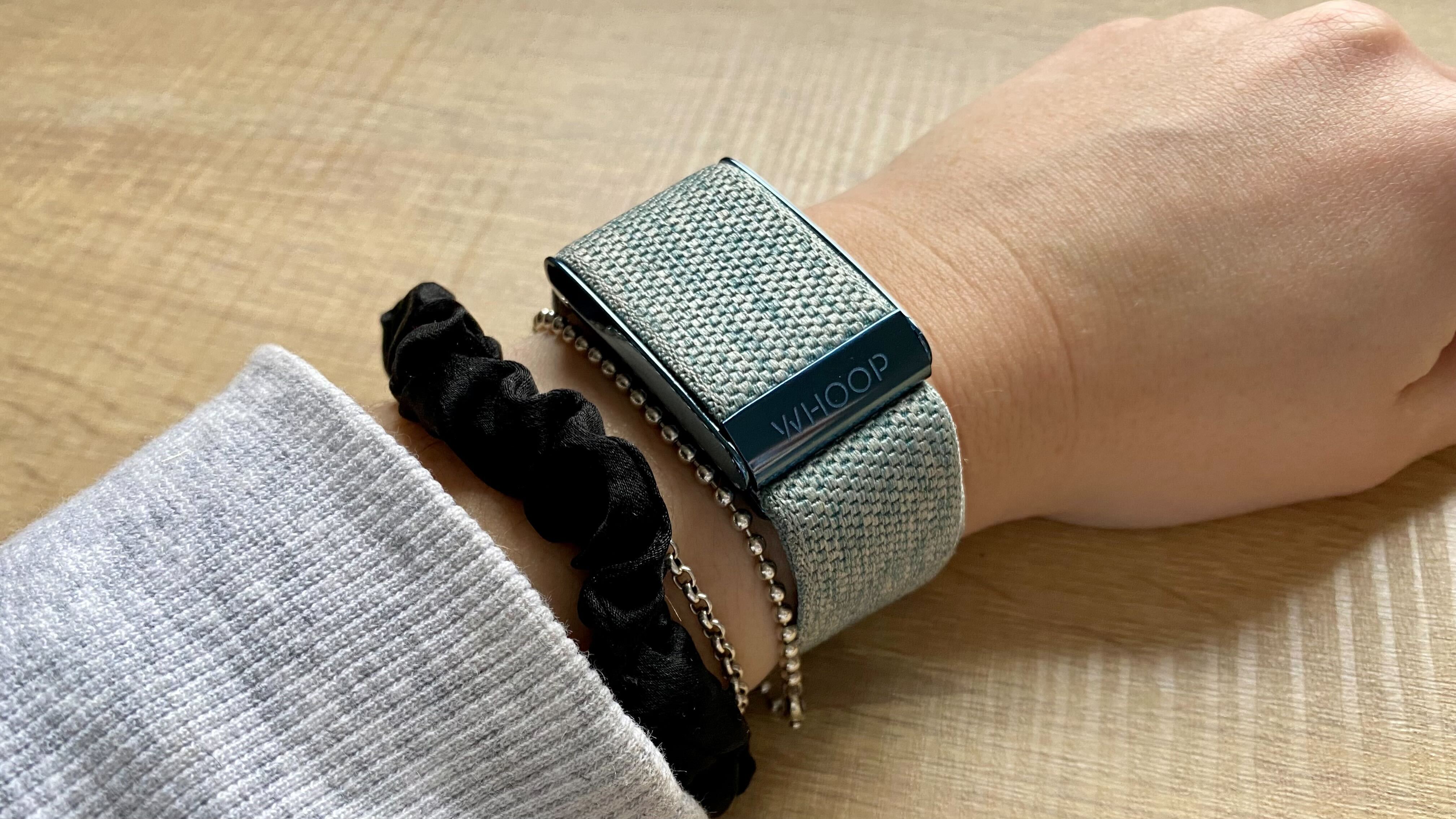 A photo of the Whoop 4.0 with a blue band on the wrist