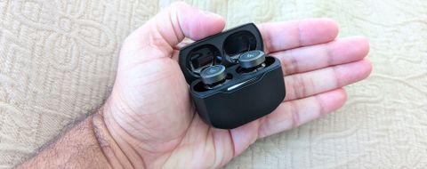 Edifier W240TN ANC earbuds in charging case placed in palm of hand
