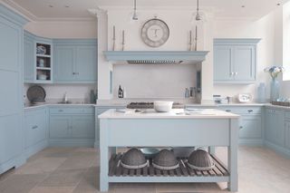 Kitchen in pale blue with island in front with u-shape