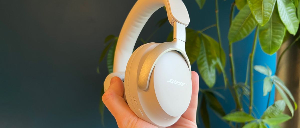 Bose QuietComfort Ultra Headphones held in a man&#039;s hand