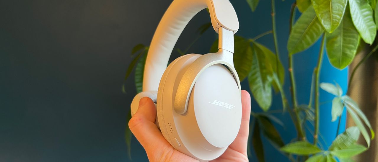 Bose QuietComfort Ultra Headphones held in a man's hand