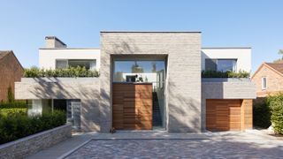 contemporary home with oversized front door and hedging