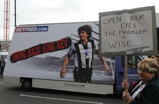 Newcastle United supporters protest against club owner Mike Ashley and Director of Football Dennis Wise before the match as a mobile billboard drives past calling for the re-stating of Kevin Keegan as manager
