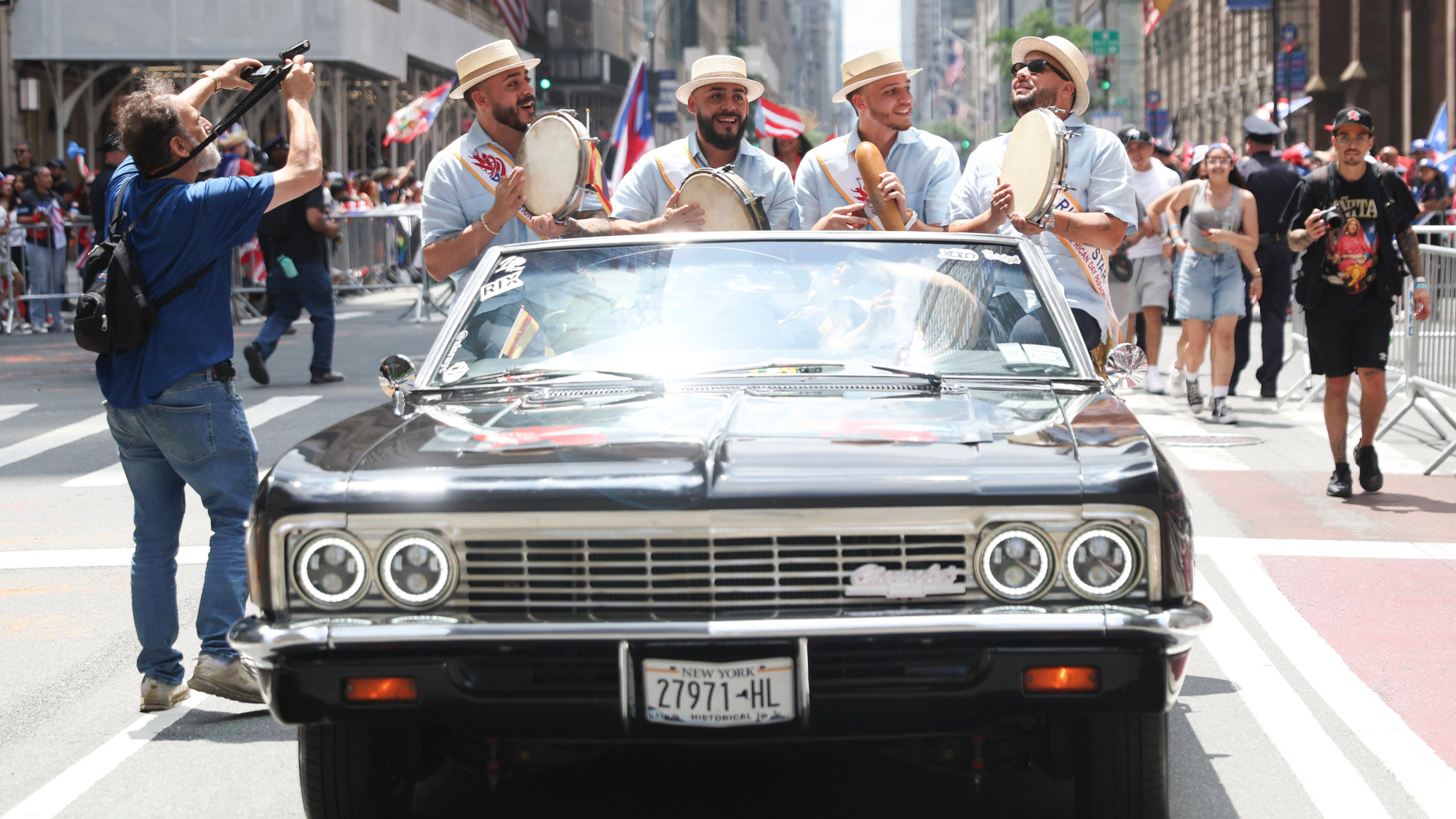 Four men ride in the back of a car