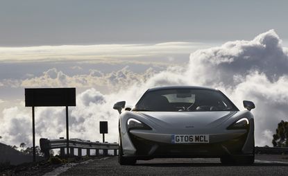 A front-on photo of the 570GT with a cloudy sky in the background. 