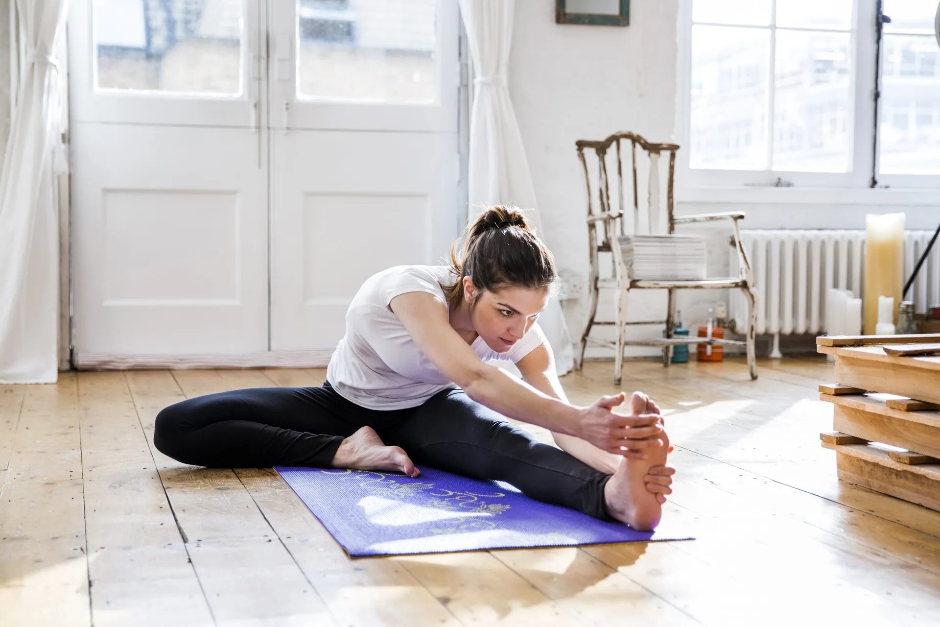 Woman stretching at home before working out at home