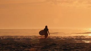 Alexandra Daddario emerges out of the water in the Baywatch movie.