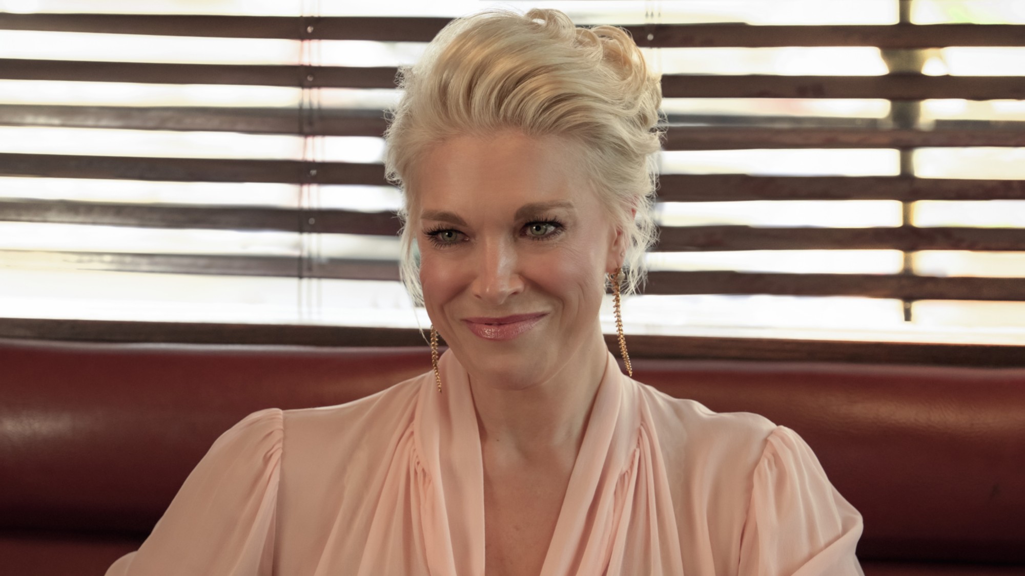 Hannah Waddingham smiling as Rebecca in Season 4 of Ted Lasso. 