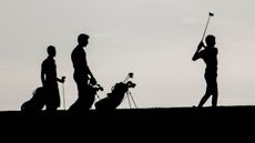 Golfers in silhouette GettyImages-163061702