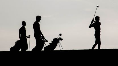 Golfers in silhouette GettyImages-163061702