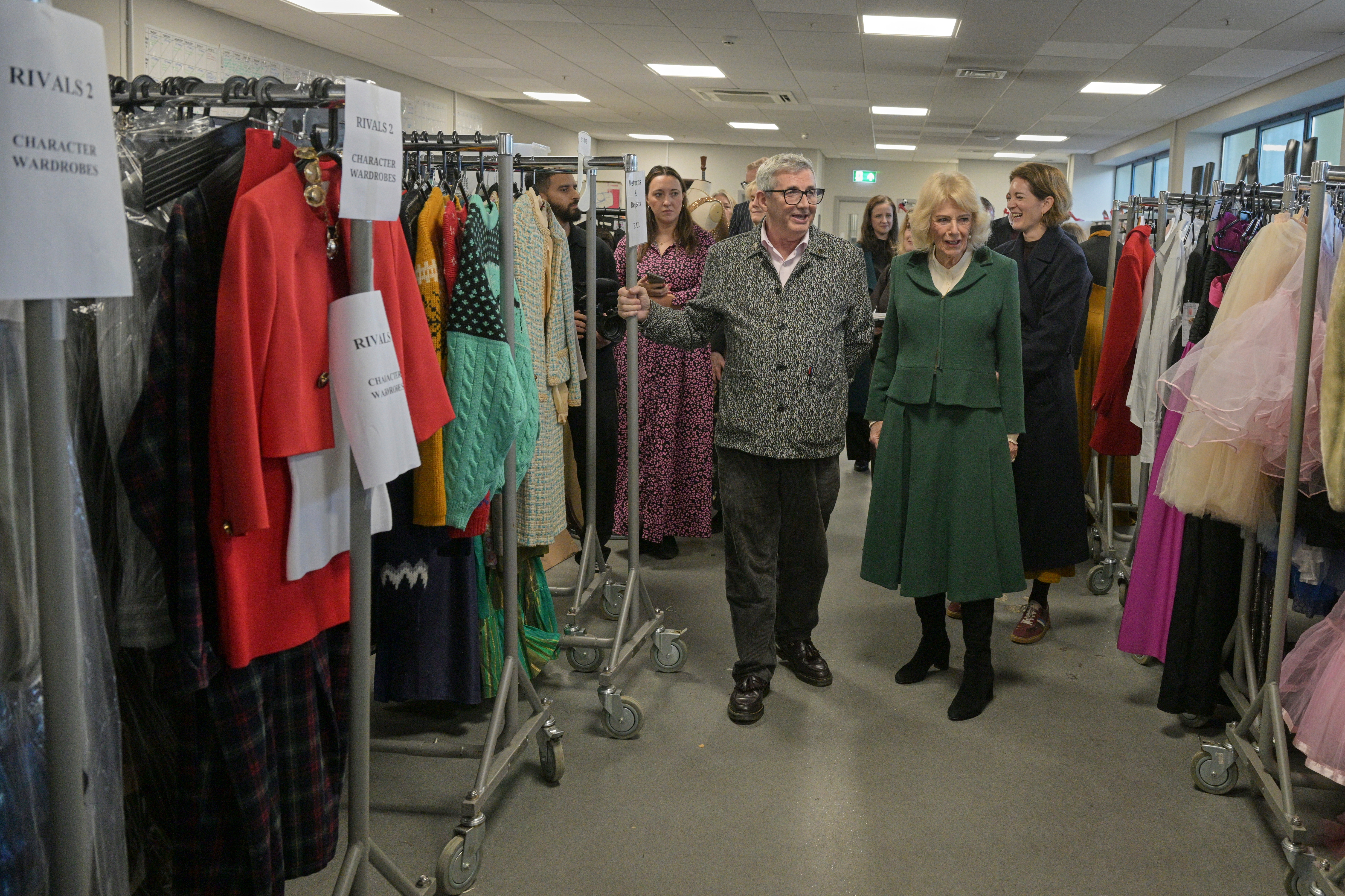 Queen Camilla walking in the costume department of the show Rivals