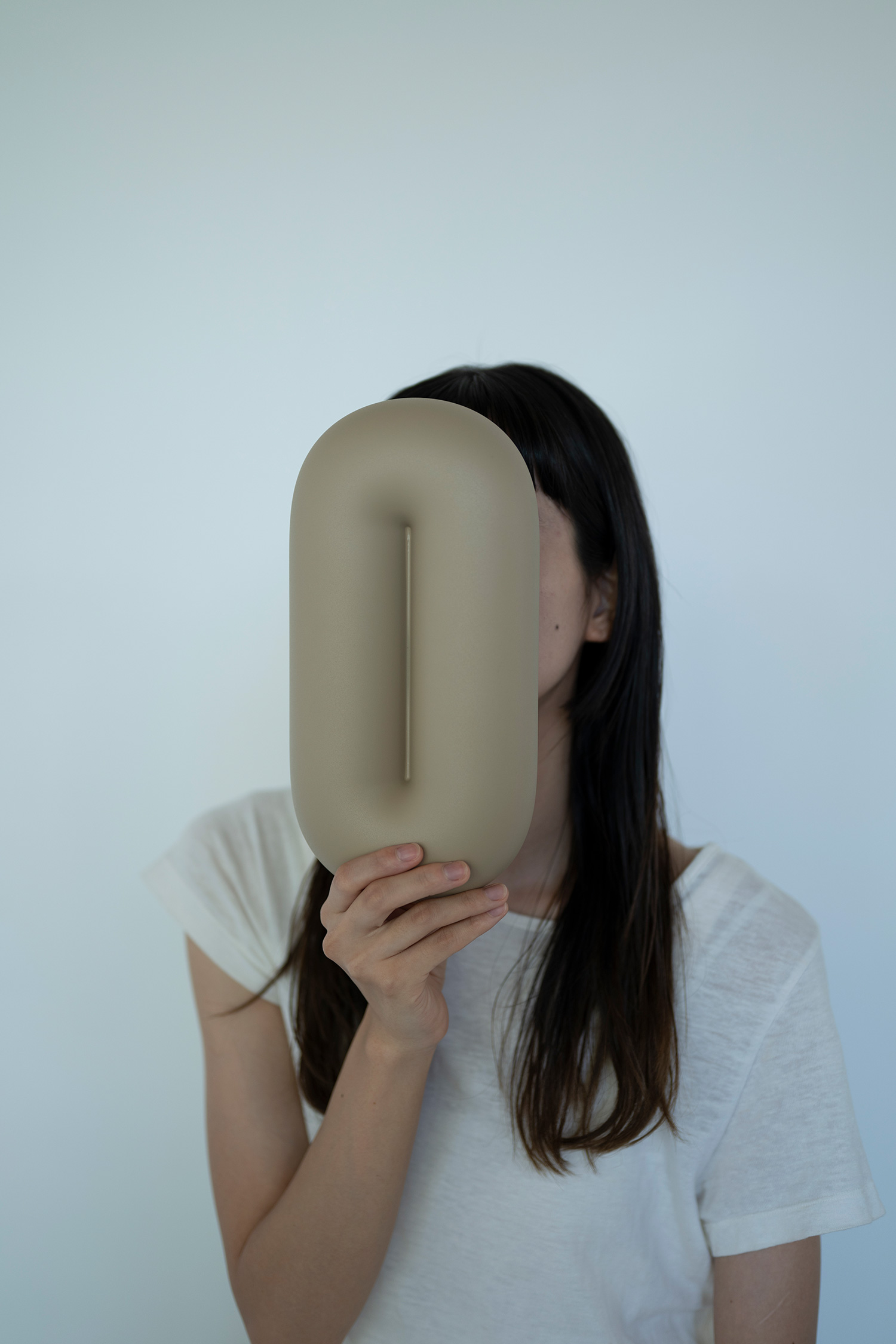person holding a beige plastic dish