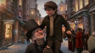 Ebenezer Scrooge smiles at Tiny Tim as he sits on his shoulder in Disney's A Christmas Carol.