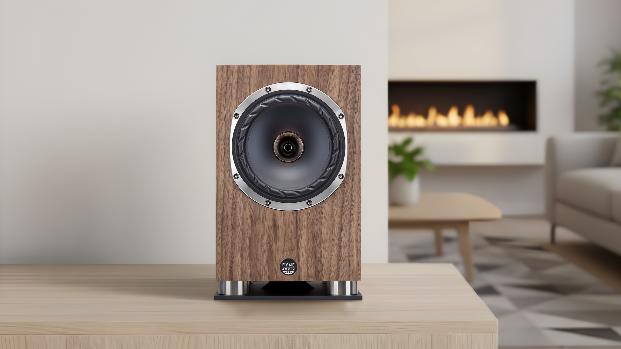 Fyne Audio F500SP Series speakers in a very neutral room with a warm fire visible in the background