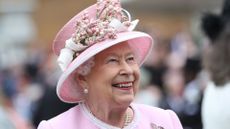Queen Elizabeth II meets guests as she attends the Royal Garden Party at Buckingham Palace on May 29, 2019