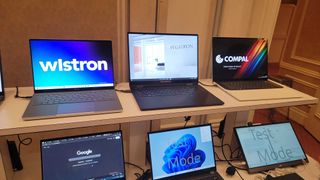 Six screens displaying Panther Lake ODM systems; three unique laptops and two mini dev systems.