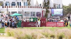 Haotong Li tees off during round one of the 2025 Qatar Masters