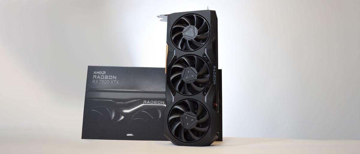 An AMD Radeon RX 7900 XTX on a table against a white backdrop