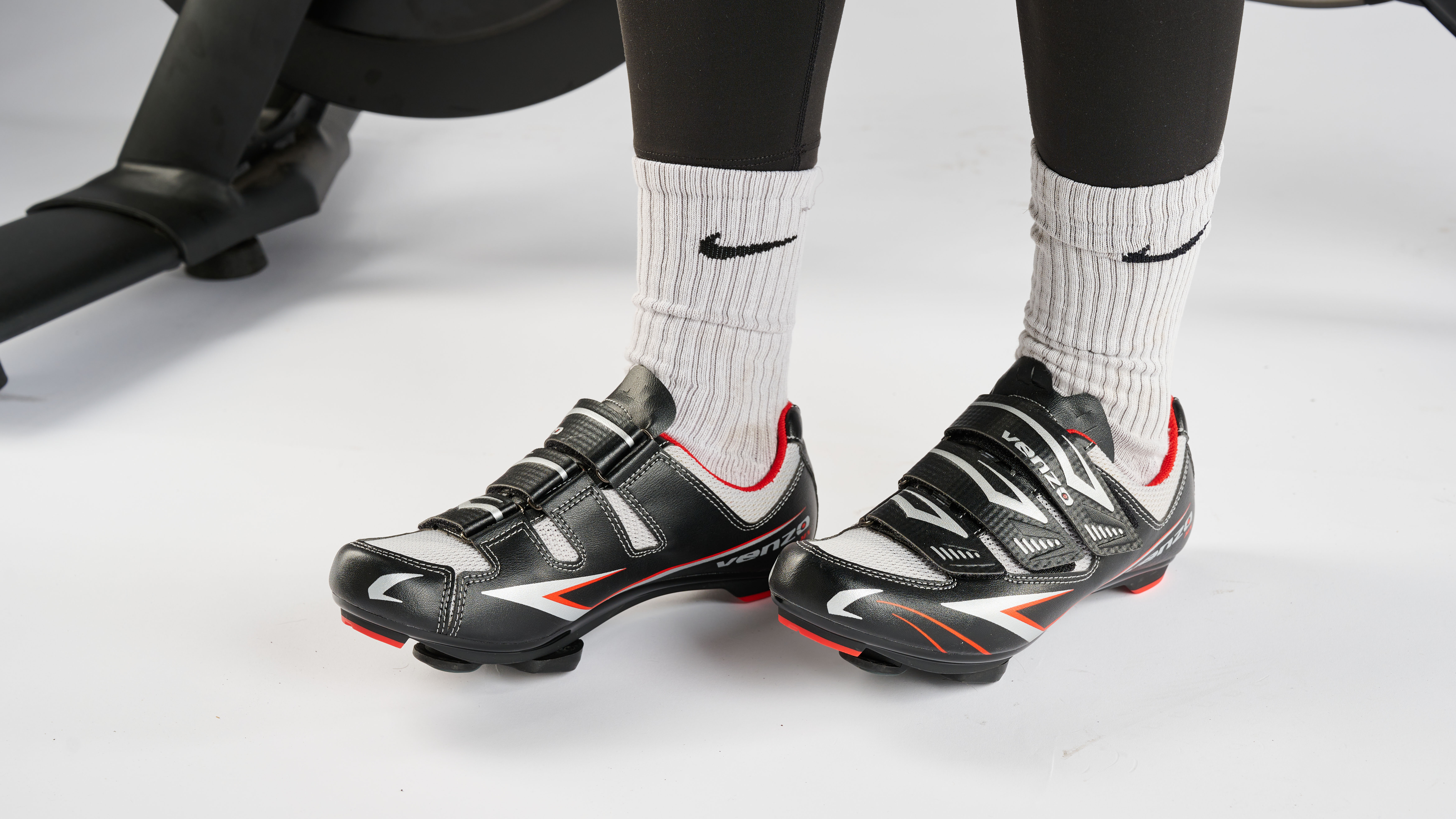 Venzo cycling shoes next to Peloton bike