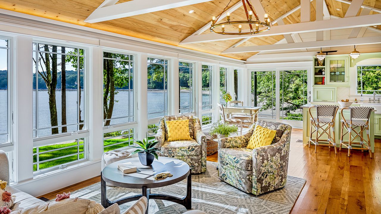 cape cod open plan living room idea with sunroom kitchen