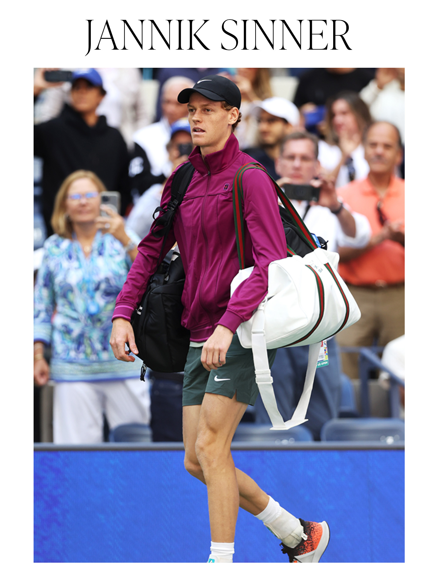 Jannik Sinner wearing a purple jacket, Nike shorts, and a white Gucci tennis bag.