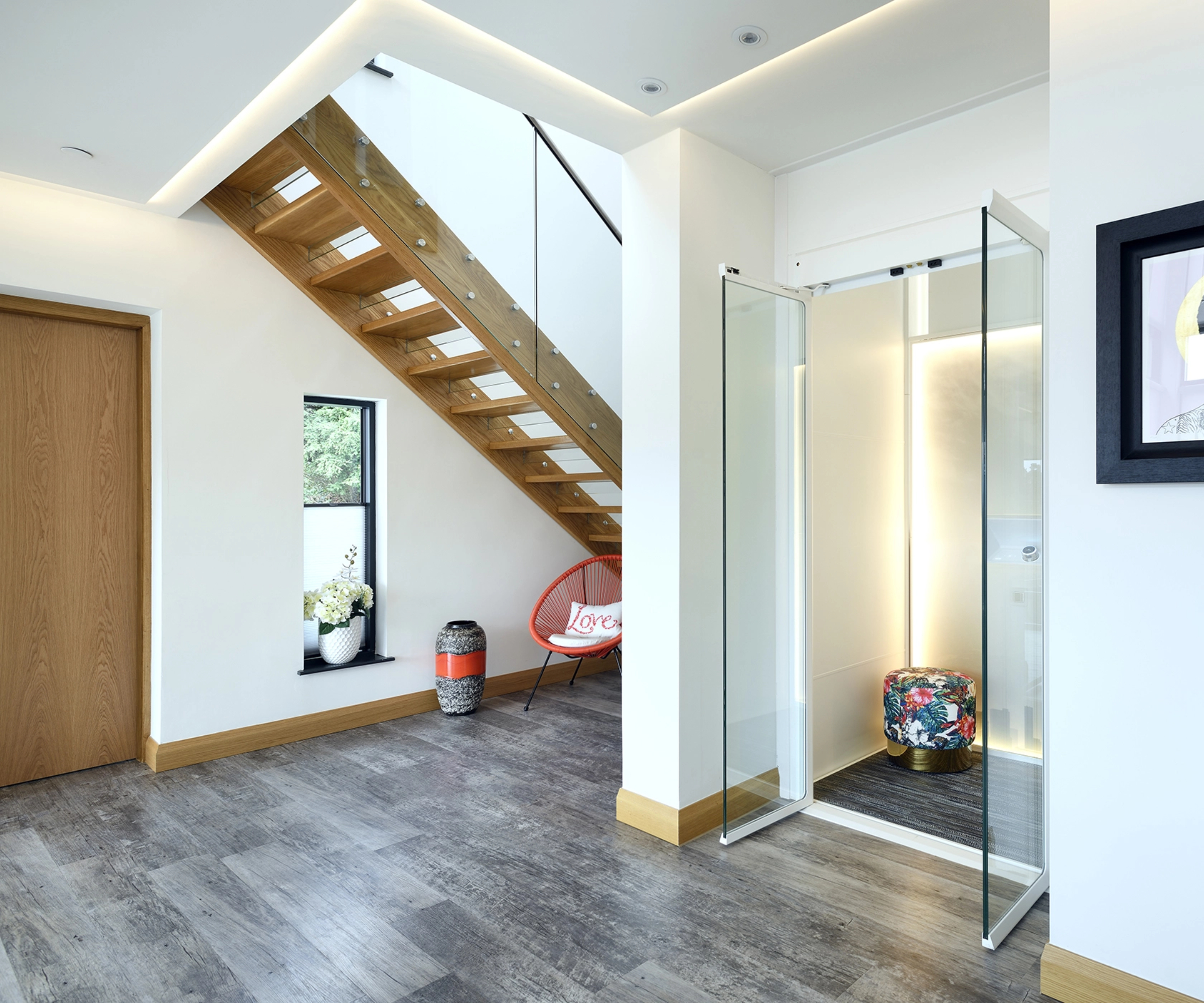 lift in hallway with glass doors and staircase to left