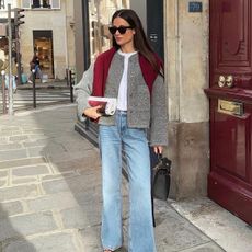 French woman wearing a gray jacket and jeans in Paris