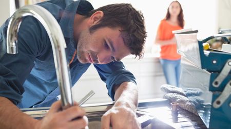 Man plumbing repairs to sink