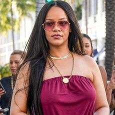Rihanna styled a strapless sporty jumpsuit with track pant-inspired stripes up each side