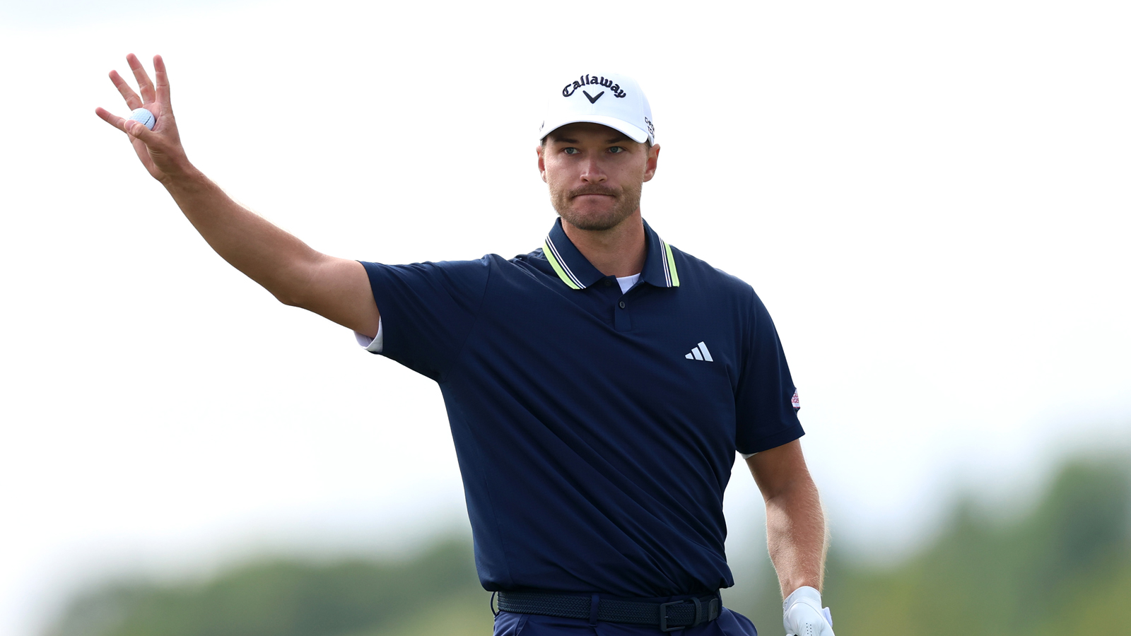 Rasmus Hojgaard waves to the crowd