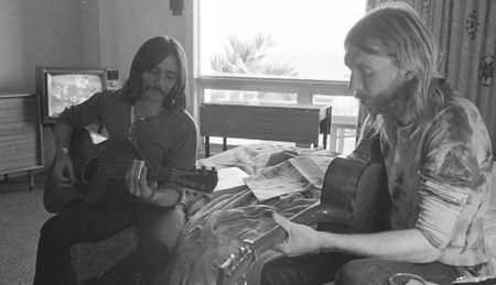 Dickey Betts (left) and Duane Allman sit in a hotel room in Spartanburg, South Carolina on October 17, 1970, playing acoustic guitars 