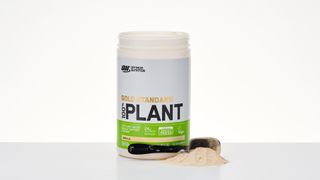 Tub of Optimum Nutrition Gold Standard 100% Plant Based Protein Powder on a table