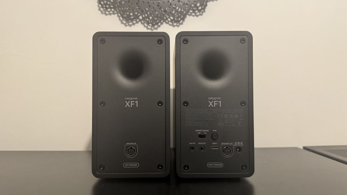 Creative XF1 speakers on a black desk