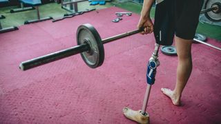 Man deadlifting properly with barbells