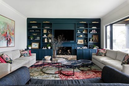 Living room with blue book shelves and entertainment center