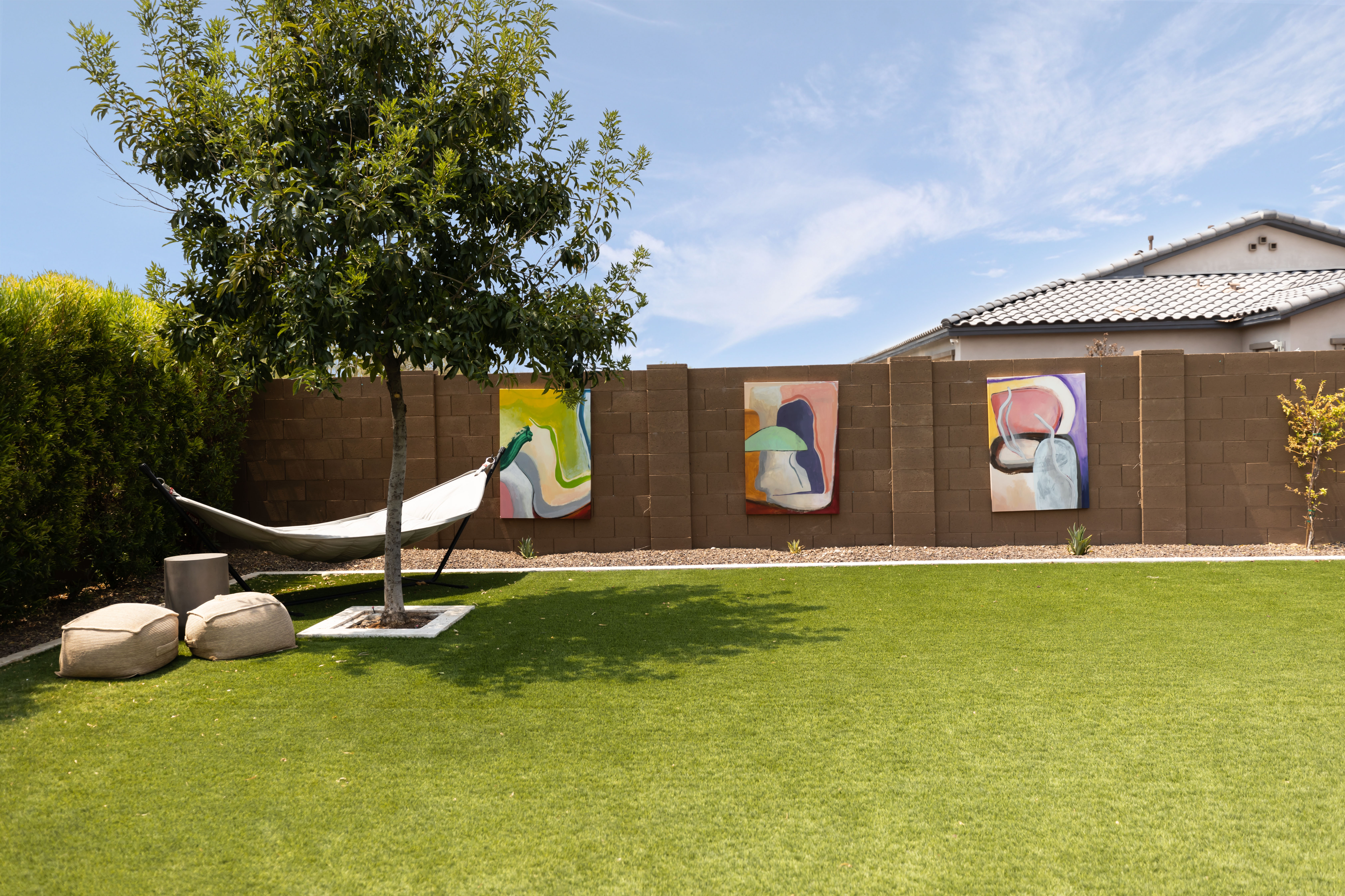 hammock in the garden with oversized art on the walls