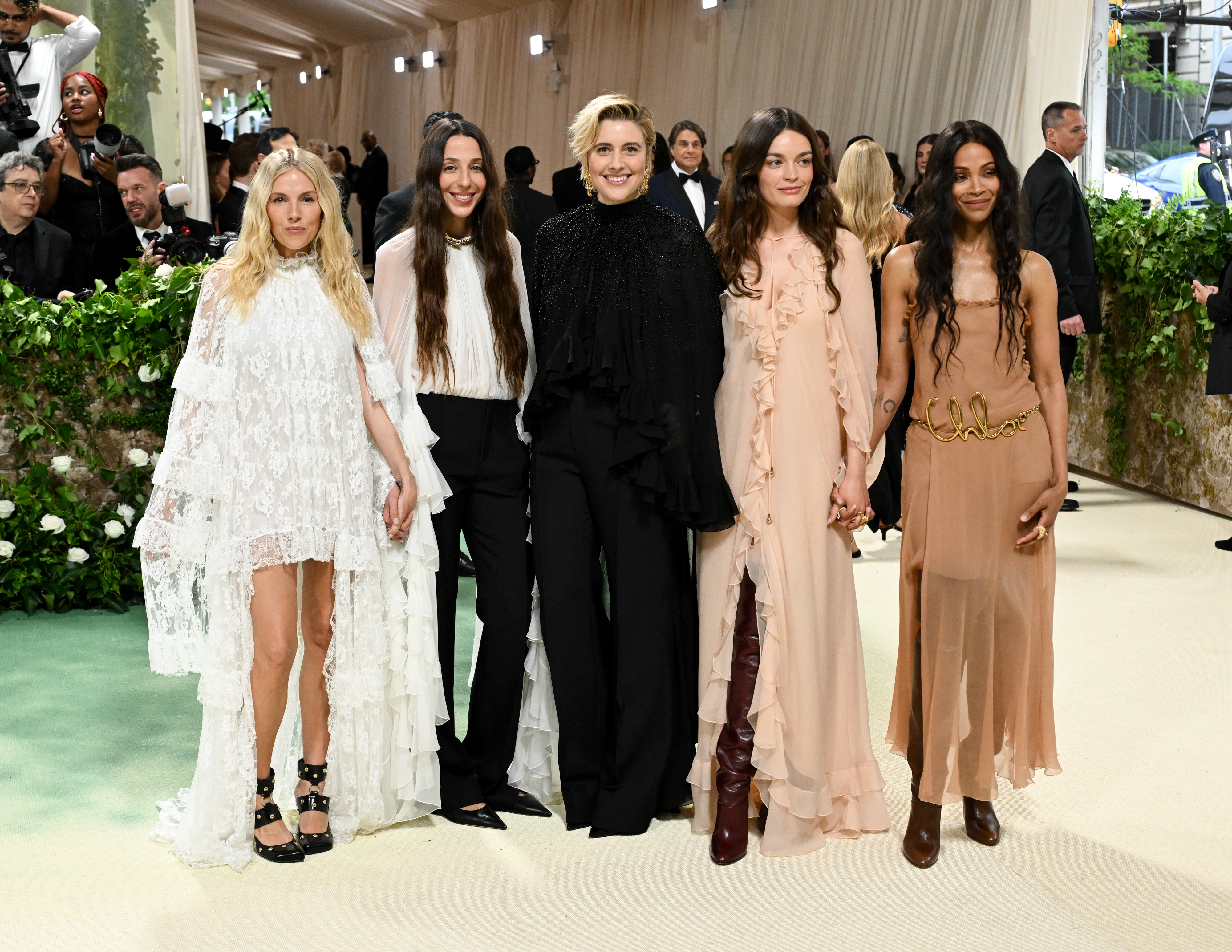 Sienna Miller wears a white lace dress Chloé dress and black studded shoes to the Met Gala 2024, joined by Chemena Kamali, Greta Gerwig, Emma Mackey and Zoe Saldana