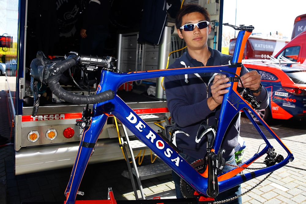 A Nippo - Vini Fantini mechanic works on a team bike.