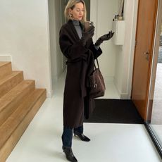 Anouk Yve in a brown coat and The Row Margaux Bag