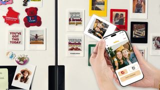 The VidaBay Snap with a smartphone updating the photos on the small e-ink screen with several more e-ink magnets int he background