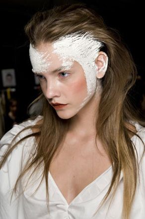 Female model with white paint near hair line