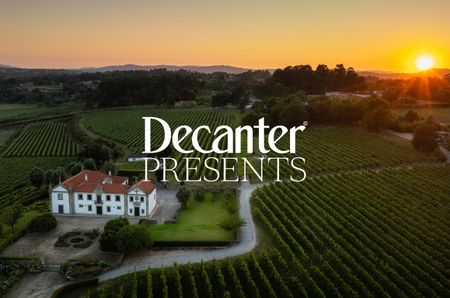 Birds eye view of vines with a white house in shot, and "Decanter Presents' in white over the top
