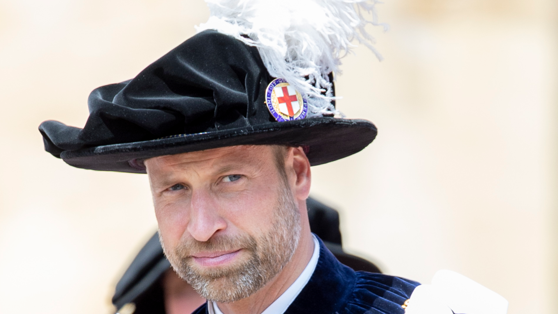 Prince William wearing a plumed hat and a cape