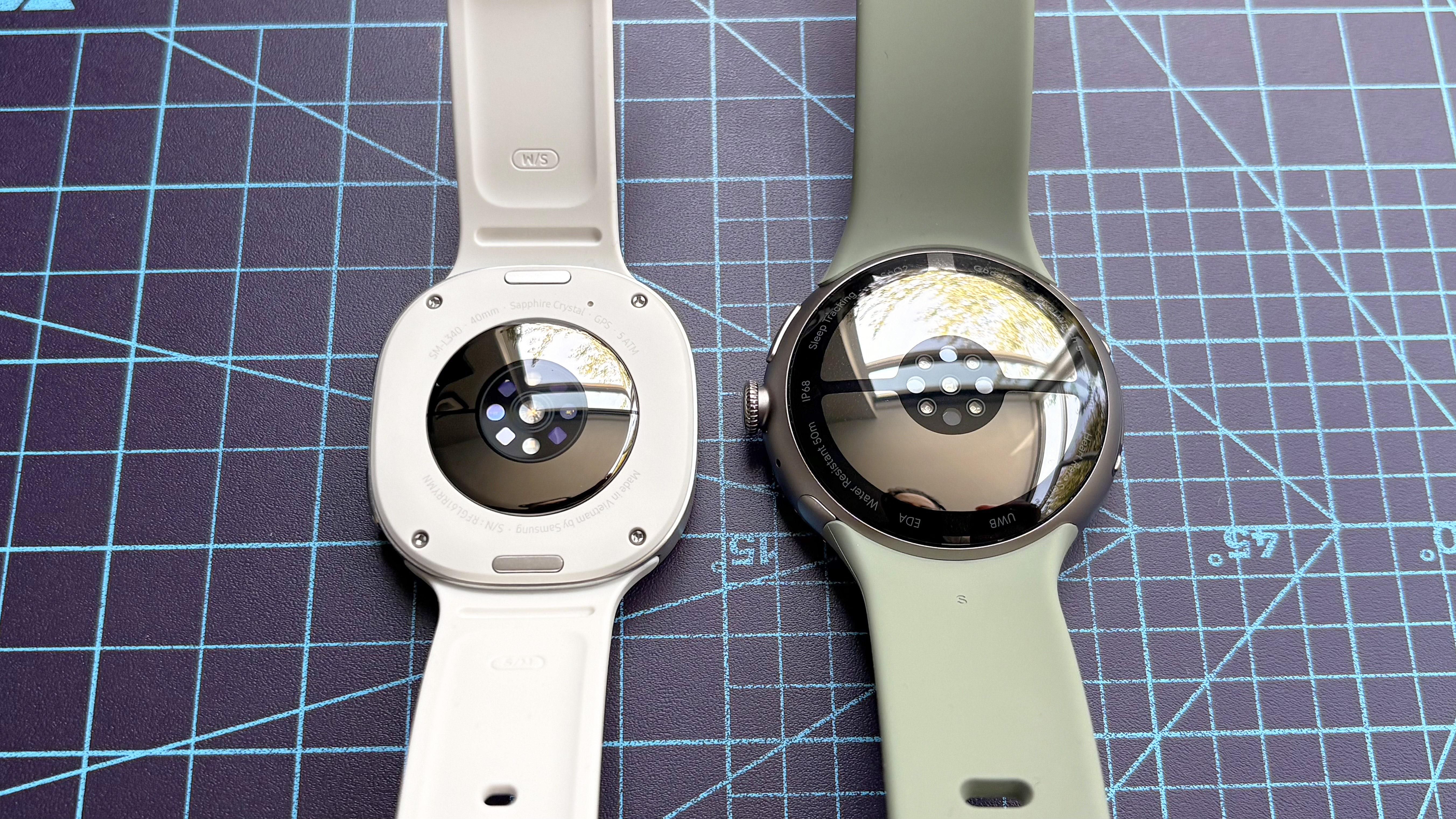 Close-up of the Samsung Galaxy Watch 9 next to the Google Pixel Watch 5