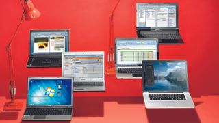 Six laptops under $500 on red surfaces against a red background